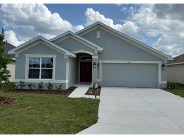Charming single-story home with a well-maintained lawn and two car garage at 2150 Nw 23Rd Loop, Ocala, FL 34475