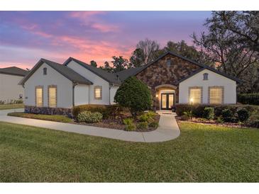 Charming single-story home with stone accents, manicured lawn, and inviting walkway at 4103 Se 10Th Ave, Ocala, FL 34480