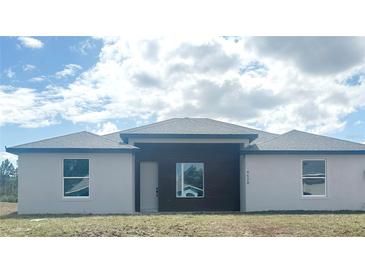 New construction home featuring a modern exterior design with a mix of textures and light-colored stucco at 4524 Sw 110Th St, Ocala, FL 34476