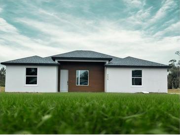 Beautiful single-story home boasting a modern design, fresh green grass, and a well-manicured lawn at 4524 Sw 110Th St, Ocala, FL 34476
