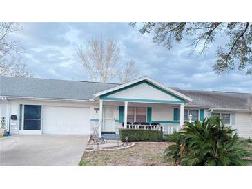 Charming single-story home featuring a cozy front porch and attached one-car garage at 8685 Sw 94Th Ln # B, Ocala, FL 34481