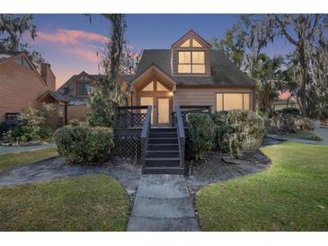 Charming two-story home featuring a symmetrical roof, complimented by a cozy front porch with inviting steps and lush shrubbery at 1621 Ne 2Nd St # 601, Ocala, FL 34470