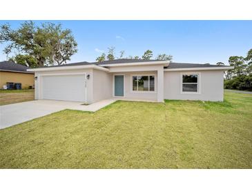Newly built single Gathering home with an attached garage and a well-manicured front lawn at 22 Juniper Drive Crse, Ocala, FL 34480