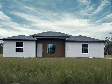 New construction, single-story home featuring white walls, a modern wood accent, and a well-manicured lawn at 4501 Sw 110Th Ln, Ocala, FL 34476