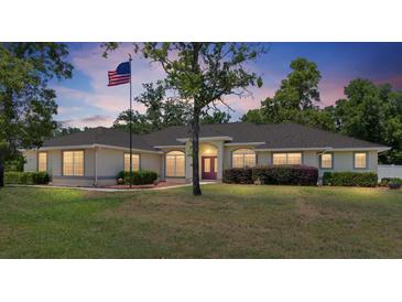 Charming single-story home featuring lush landscaping and a welcoming front entrance at 6279 Se 8Th Lane, Ocala, FL 34472