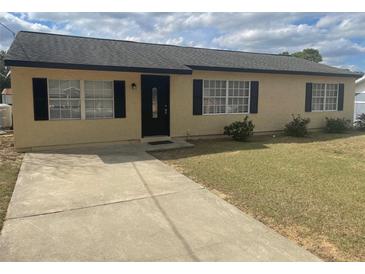 Charming single-story home featuring a well-manicured front yard and a welcoming entrance at 4 Pine Pass Ter, Ocala, FL 34472