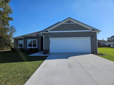 Well maintained single story home with a 2 car garage and a manicured front lawn at 4838 Sw 130Th St, Ocala, FL 34473