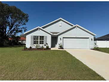 Charming single-story home with a well-manicured lawn and attached two-car garage at 243 Marion Oaks Trl, Ocala, FL 34473