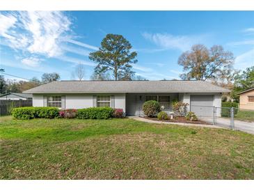 Charming single story home featuring manicured landscaping with vibrant green bushes and azaleas in front yard at 3204 Ne 16Th Ave, Ocala, FL 34479