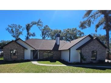 Charming single story brick home featuring manicured lawn and attractive roof line at 4534 Se 13Th St, Ocala, FL 34471