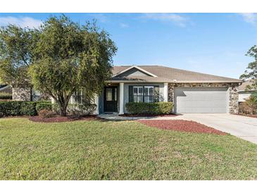 Charming single Gathering home with a well-manicured lawn and a two-car garage at 4731 Se 32Nd St, Ocala, FL 34480