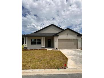 Charming single-story home featuring a neutral color scheme and a well-maintained front yard at 4780 Se 25Th Loop, Ocala, FL 34480