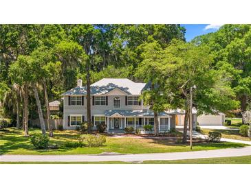 Charming two-story home with a covered porch and mature trees, providing ample shade and curb appeal at 1628 Se 29Th Ter, Ocala, FL 34471