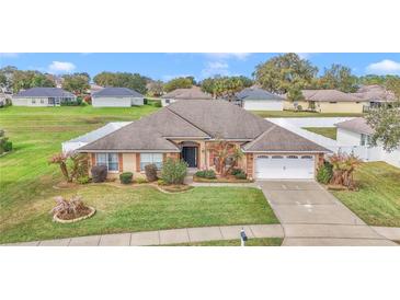 Charming single-story home boasts lush landscaping, a two-car garage, and a well-maintained lawn at 4839 Sw 63Rd St, Ocala, FL 34474