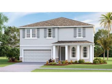 Charming two-story home showcasing a manicured lawn, neutral color palette, and an attached two car garage at 4266 Sw 53Rd Lane Rd, Ocala, FL 34474