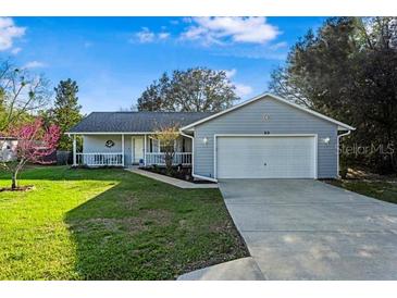 Charming single-story home with well-maintained lawn and attached two-car garage at 53 Juniper Trail Cir, Ocala, FL 34480