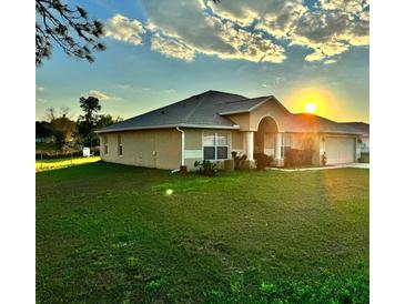 Charming single-story home with well-manicured lawn and bright sunlight at 17 Pine Course Loop, Ocala, FL 34472