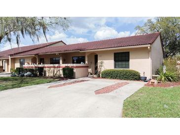 Charming single-story villa with a tile roof, manicured landscaping, and inviting curb appeal at 3447 Sw 19Th Pl, Ocala, FL 34474