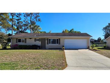 Charming single-story home features a well-maintained lawn, attached garage, and a cozy, inviting facade at 8516 Sw 105Th Pl, Ocala, FL 34481