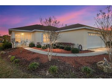 Charming single-story home with a well-manicured lawn, mature landscaping and two car garage at 10071 Sw 90Th Loop, Ocala, FL 34481