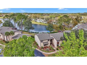 Scenic lake view property featuring well-maintained landscaping, mature trees, and a community overlooking the water at 615 Midway Dr # B, Ocala, FL 34472