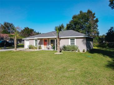 Charming single-story home with well-manicured lawn and inviting front porch seating area at 622 Nw 56Th Ave, Ocala, FL 34482