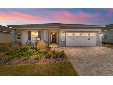 Charming single-story home featuring a two-car garage, a brick-paved driveway, and well-maintained landscaping at 7908 Sw 89Th Cir, Ocala, FL 34481