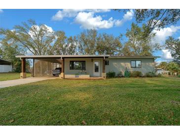 Inviting home with covered carport, manicured lawn, and a welcoming entryway, perfect for suburban living at 8917 Sw 101St Ln, Ocala, FL 34481
