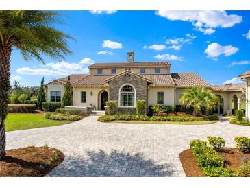 Stunning two-story home with a stone accent, manicured lawn, and a circular driveway at 12424 Sw 140Th Loop, Dunnellon, FL 34432