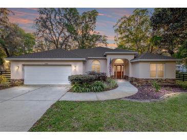 Charming single-story home featuring a two-car garage, manicured lawn, and inviting curb appeal at 13920 Ne 38Th Ave, Anthony, FL 32617