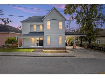 Charming two-story home boasting classic architecture, a covered porch, and a convenient carport at 30 Se Wenona Ave, Ocala, FL 34471
