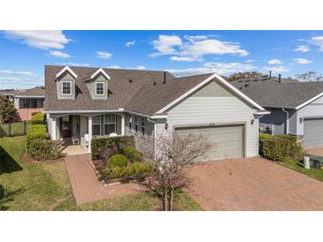 Charming single-Gathering home boasts two dormers, a brick driveway, and a well-manicured lawn at 5563 Nw 40Th Pl, Ocala, FL 34482