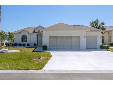 Charming single-story home with a three-car garage and well-manicured lawn at 5916 Nw 27Th Pl, Ocala, FL 34482