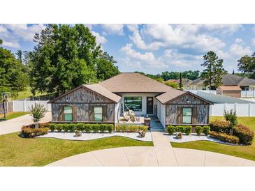 Charming single-story home with custom wood accents, lush landscaping, and a welcoming front porch at 6125 Se 11Th St, Ocala, FL 34472
