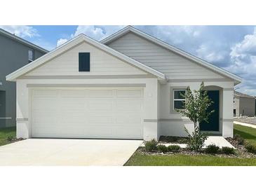 Charming single-story home featuring a two-car garage, tidy landscaping, and a classic architectural design at 2171 Ne 28Th Ln, Ocala, FL 34470