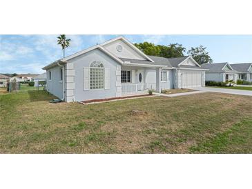Charming single-story home with a well-maintained lawn and attached garage at 5347 Nw 20Th Pl, Ocala, FL 34482