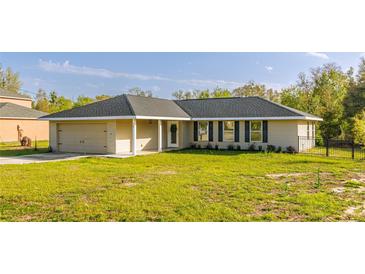 Charming single-story home featuring a well-manicured lawn and an attached garage at 75 Pine Crse, Ocala, FL 34472