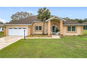 Charming single Gathering home featuring a well-manicured lawn and attached two-car garage at 7955 Sw 62Nd Ct, Ocala, FL 34476