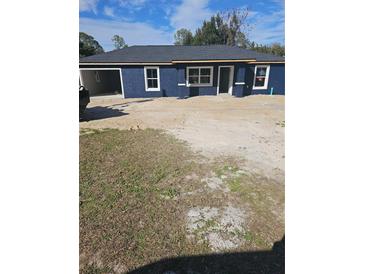 Newly constructed one-story home featuring a stucco exterior, contrasting trim, and an attached garage at 1929 Sw 7Th Pl, Ocala, FL 34474