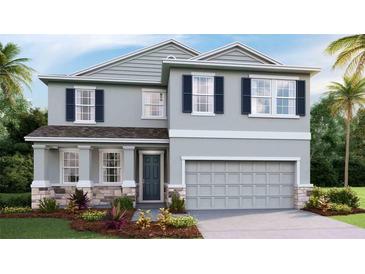 Charming two-story home with blue shutters, stone accents, and a two car garage at 4236 Sw 53Rd Lane Rd, Ocala, FL 34474