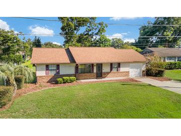 Well-maintained home featuring mature landscaping, a lush lawn, and an inviting curb appeal at 22 Banyan Dr, Ocala, FL 34472
