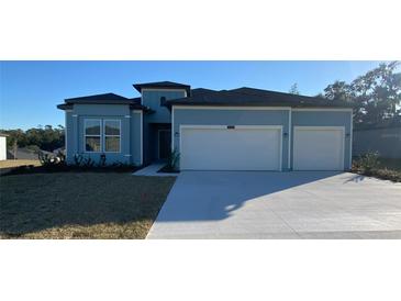 Charming single-Gathering home with a two-car garage, well-maintained lawn, and manicured landscaping at 19444 Sw 78Th Pl, Dunnellon, FL 34432