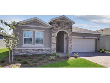 Charming single-Gathering home featuring a stone-accented entrance and a well-maintained front lawn at 4546 Nw 53Rd Avenue Rd, Ocala, FL 34482