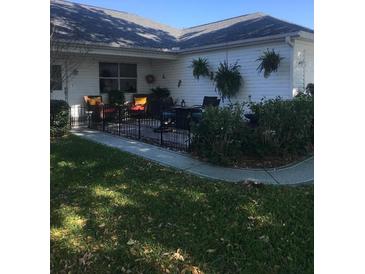 Charming patio area with comfortable seating and hanging plants at 509 Del Mar Dr, Lady Lake, FL 32159