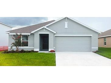 Charming single-story home with an attached two-car garage and a well-maintained front lawn at 7121 Se 113Th Ln, Belleview, FL 34420