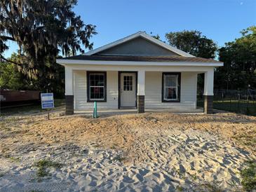 New home with white siding and covered front porch, ready for landscaping at 714 Nw 2Nd St, Ocala, FL 34475