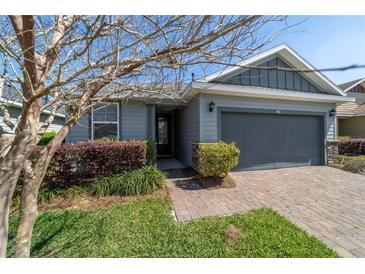 Charming single-Gathering home with a two-car garage, manicured landscaping, and a brick paver driveway at 3935 Nw 46Th Ter, Ocala, FL 34482