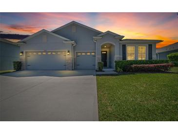 Charming single-Gathering home with a well-manicured lawn and a three-car garage at sunset at 5048 Sw 57Th Pl, Ocala, FL 34474