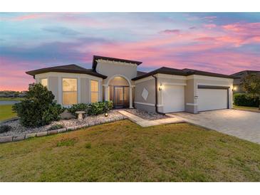 Attractive single-story home with a well-kept lawn, mature landscaping, and a spacious two-car garage at 6558 Sw 94Th Cir, Ocala, FL 34481