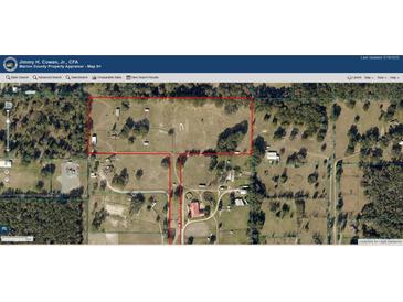 Aerial view of the property showcasing the expansive land and wooded areas at 10750 Nw 7Th St, Ocala, FL 34482